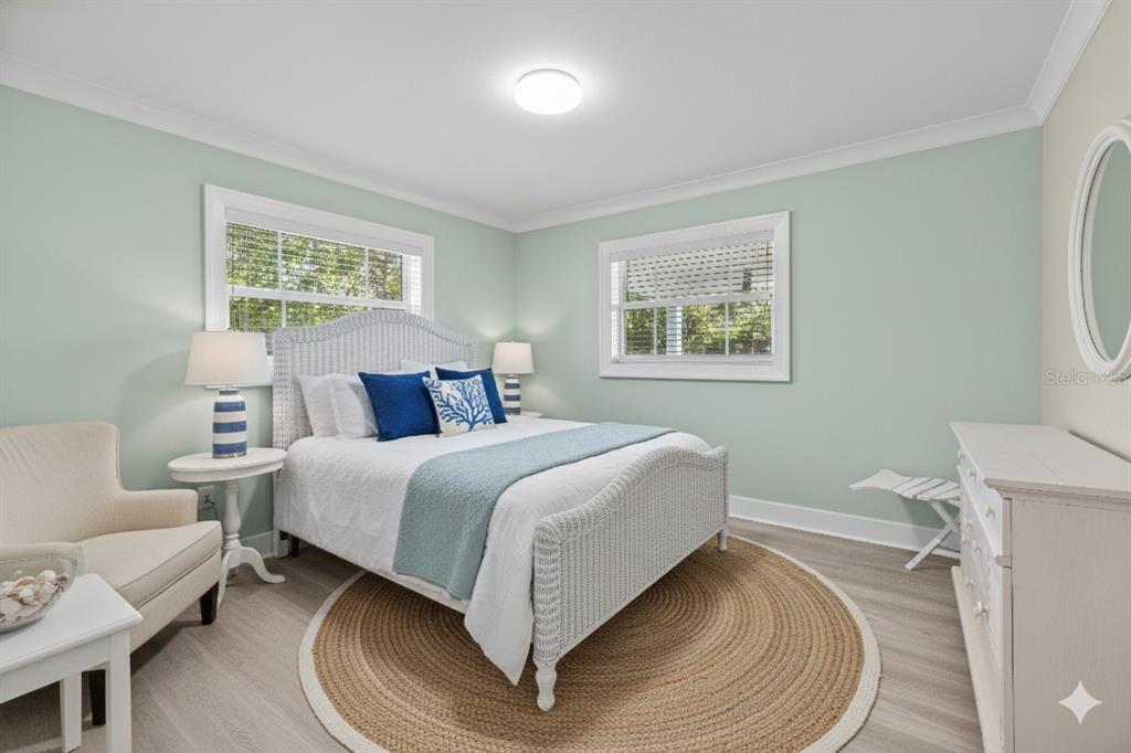 8552 Lagoon Road Fort Myers Beach, FL 33931 - Photo 16 of 33 a spacious bedroom with a bed and a couch