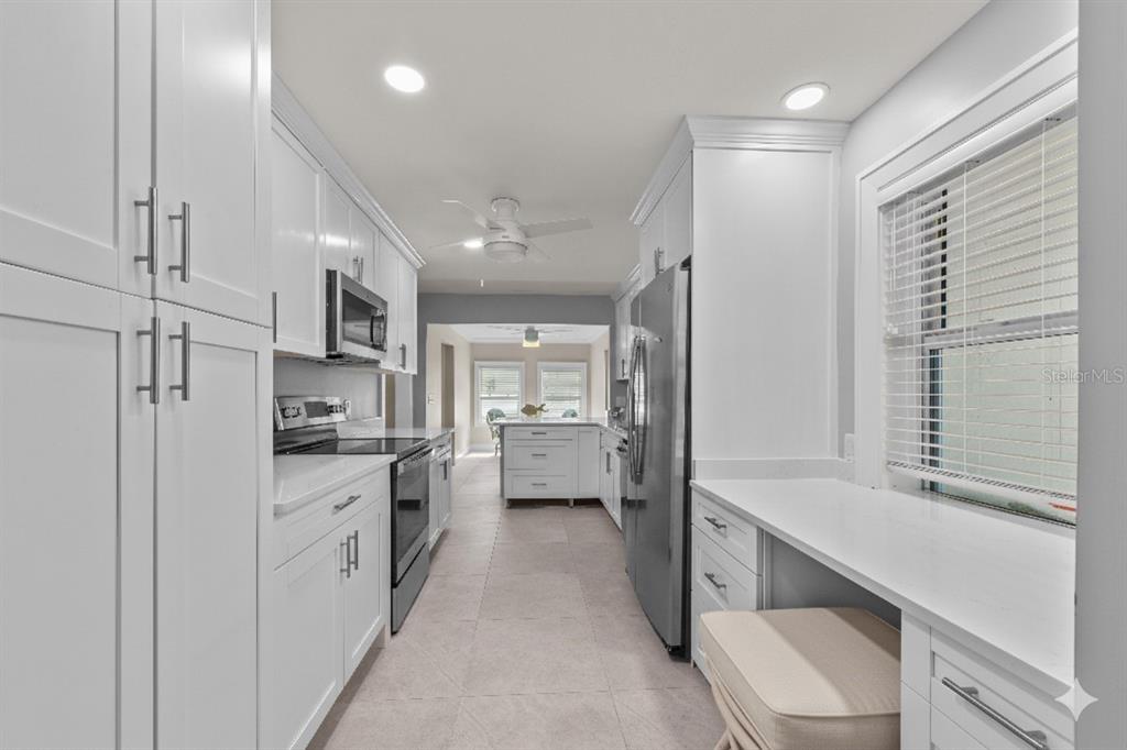 8552 Lagoon Road Fort Myers Beach, FL 33931 - Photo 6 of 33 a kitchen with white cabinets and white appliances