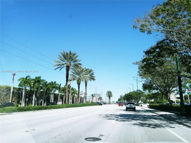 a view of a road with a house in the background
