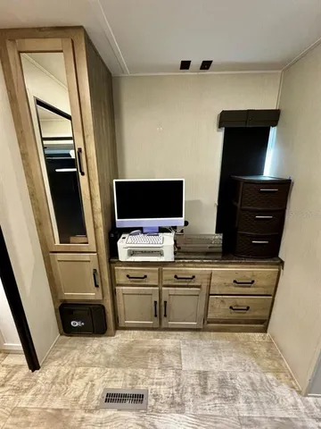 a living room with closet and flat screen tv