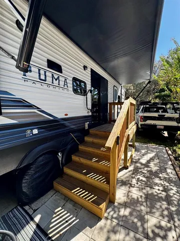 a roof deck with table and chairs