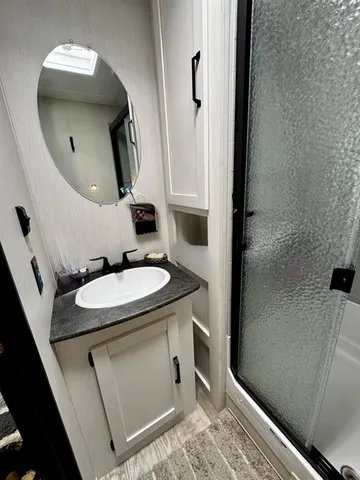 a bathroom with a sink a toilet and mirror