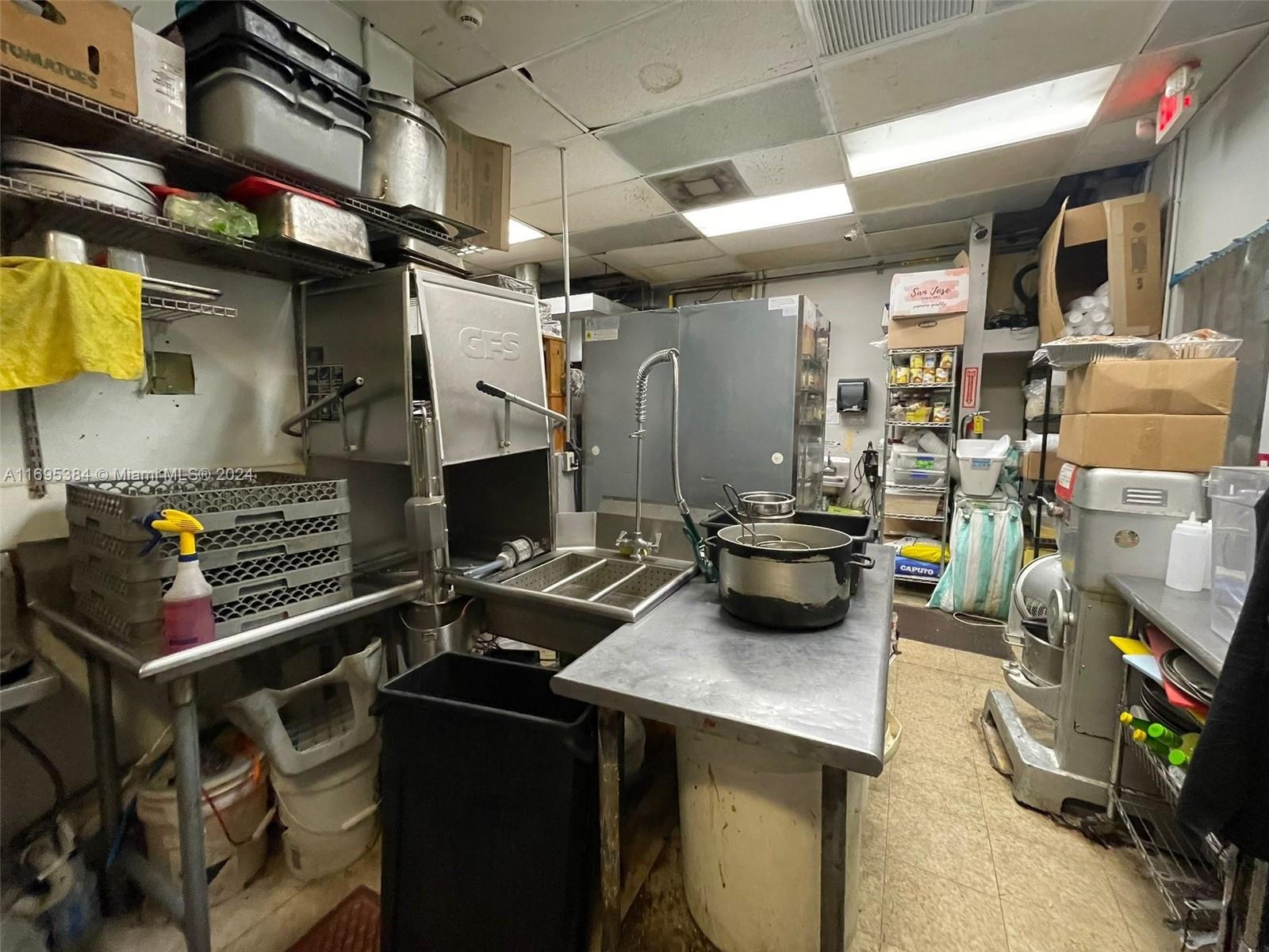 12388 Southwest 127th Avenue Miami, FL 33186 - Photo 26 of 28 a kitchen with a refrigerator and a stove