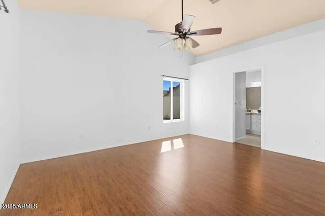 a view of a room with wooden floor closet and windows