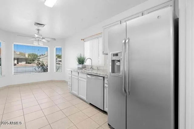 a kitchen with stainless steel appliances a refrigerator and a stove top oven