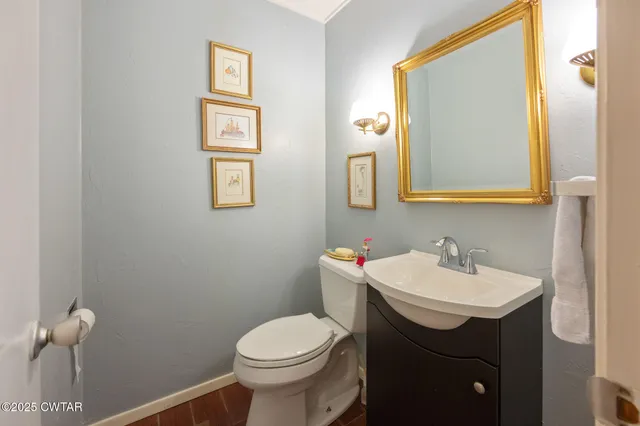 a bathroom with a sink mirror and toilet
