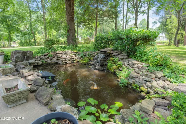 a backyard of a house with a yard with outdoor seating