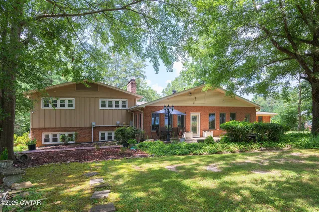 a front view of a house with a yard and porch