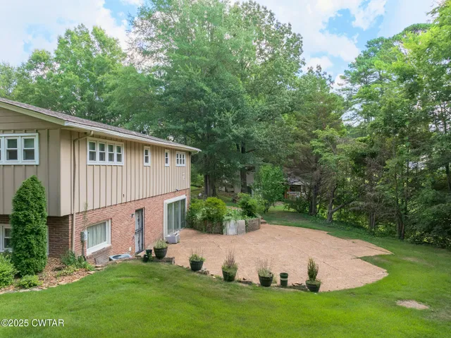 a view of house with backyard and garden