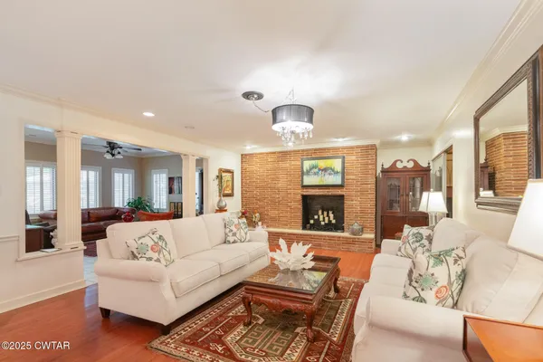 a view of a living room kitchen and a large window