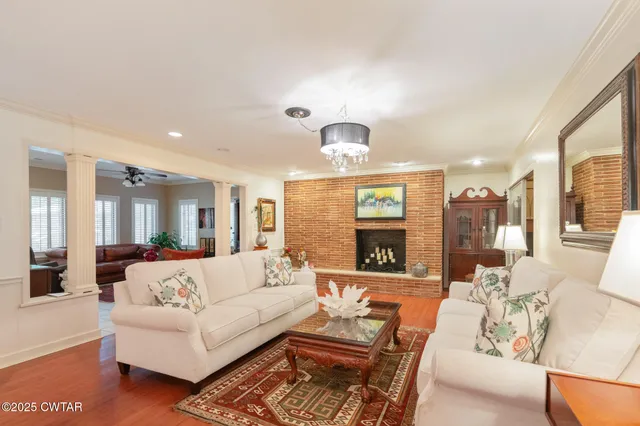 a view of a living room kitchen and a large window