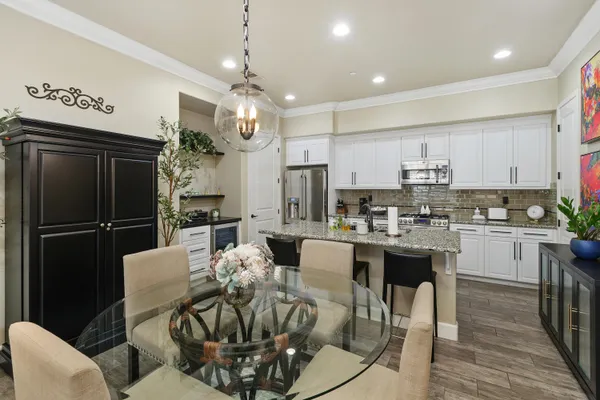a large kitchen with a table and chairs
