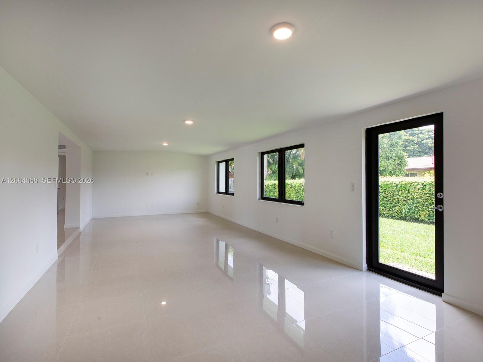 8790 Southwest 85th Street Miami, FL 33173 - Photo 10 of 20 a view of an empty room with a window