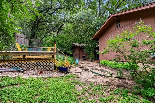 a view of a backyard with a large tree