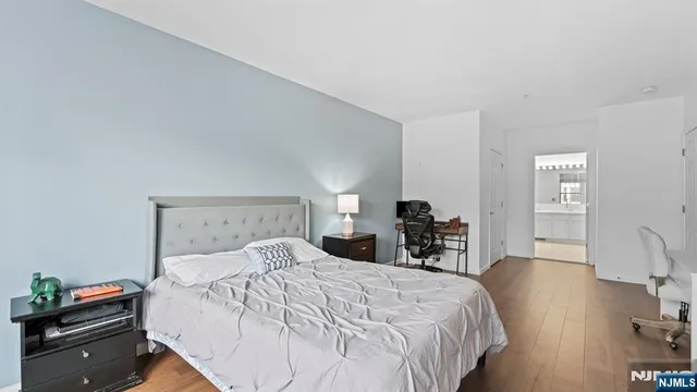 a large bed sitting in a bedroom and a table