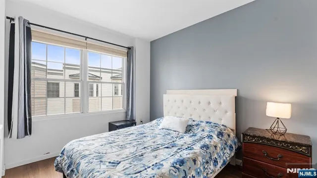 a bedroom with a large bed and a window