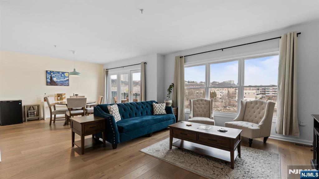 344 The Promenade, Unit 344 Edgewater, NJ 07020 - Photo 7 of 44 a living room with furniture and a large window
