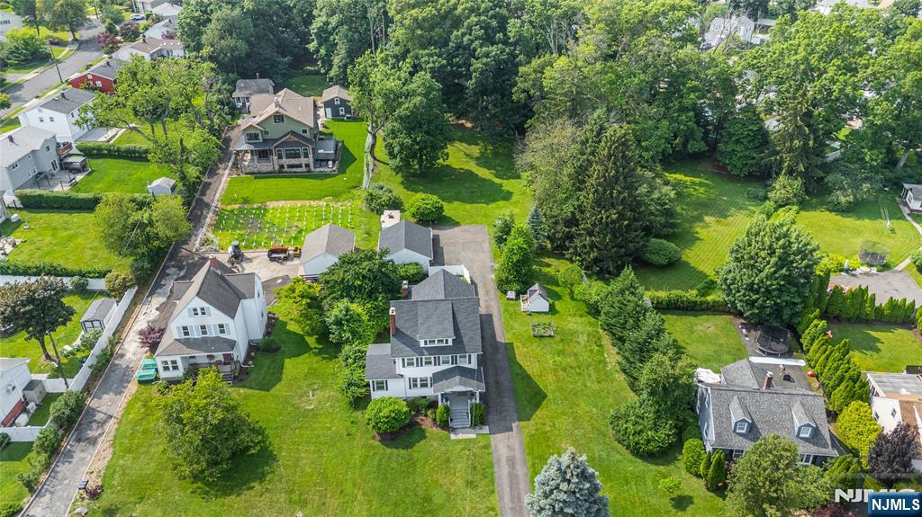 an aerial view of residential house with outdoor space and swimming pool