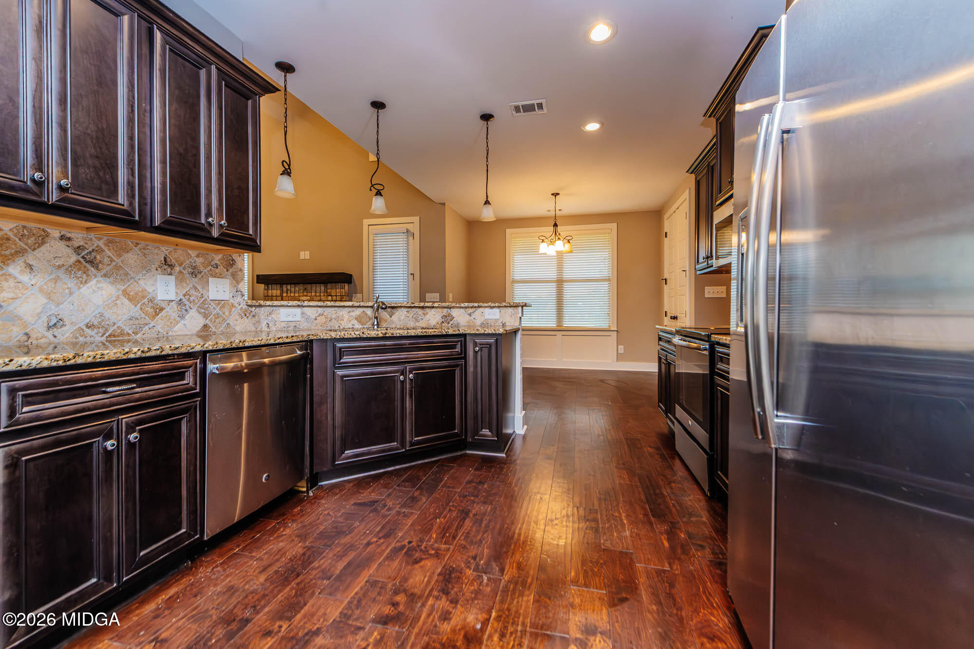 112 Agriculture Lane Perry, GA 31069 - Photo 12 of 40 a kitchen with stainless steel appliances wooden floor sink stove and cabinets