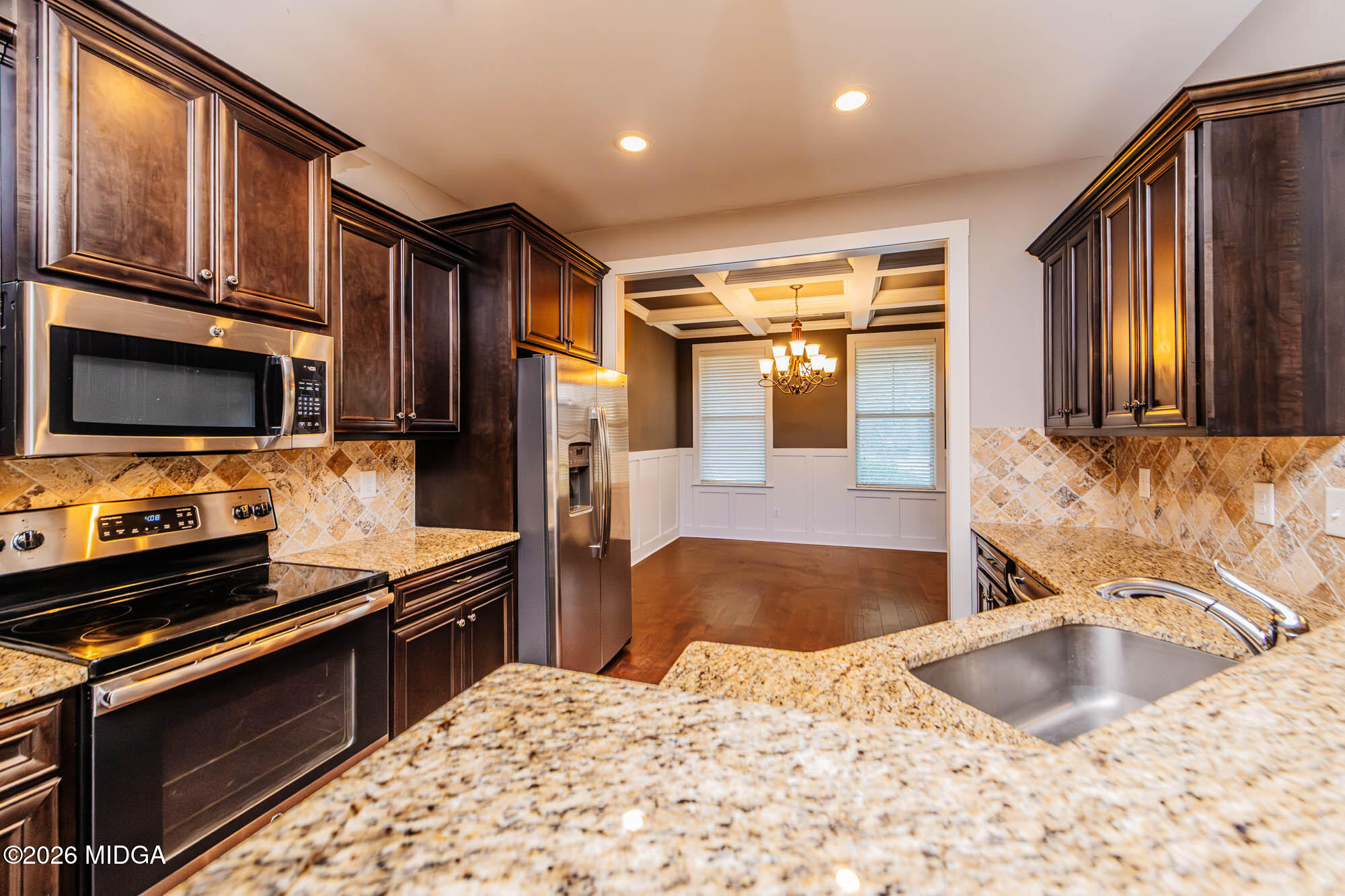 112 Agriculture Lane Perry, GA 31069 - Photo 13 of 40 a kitchen with stainless steel appliances granite countertop a sink stove and refrigerator
