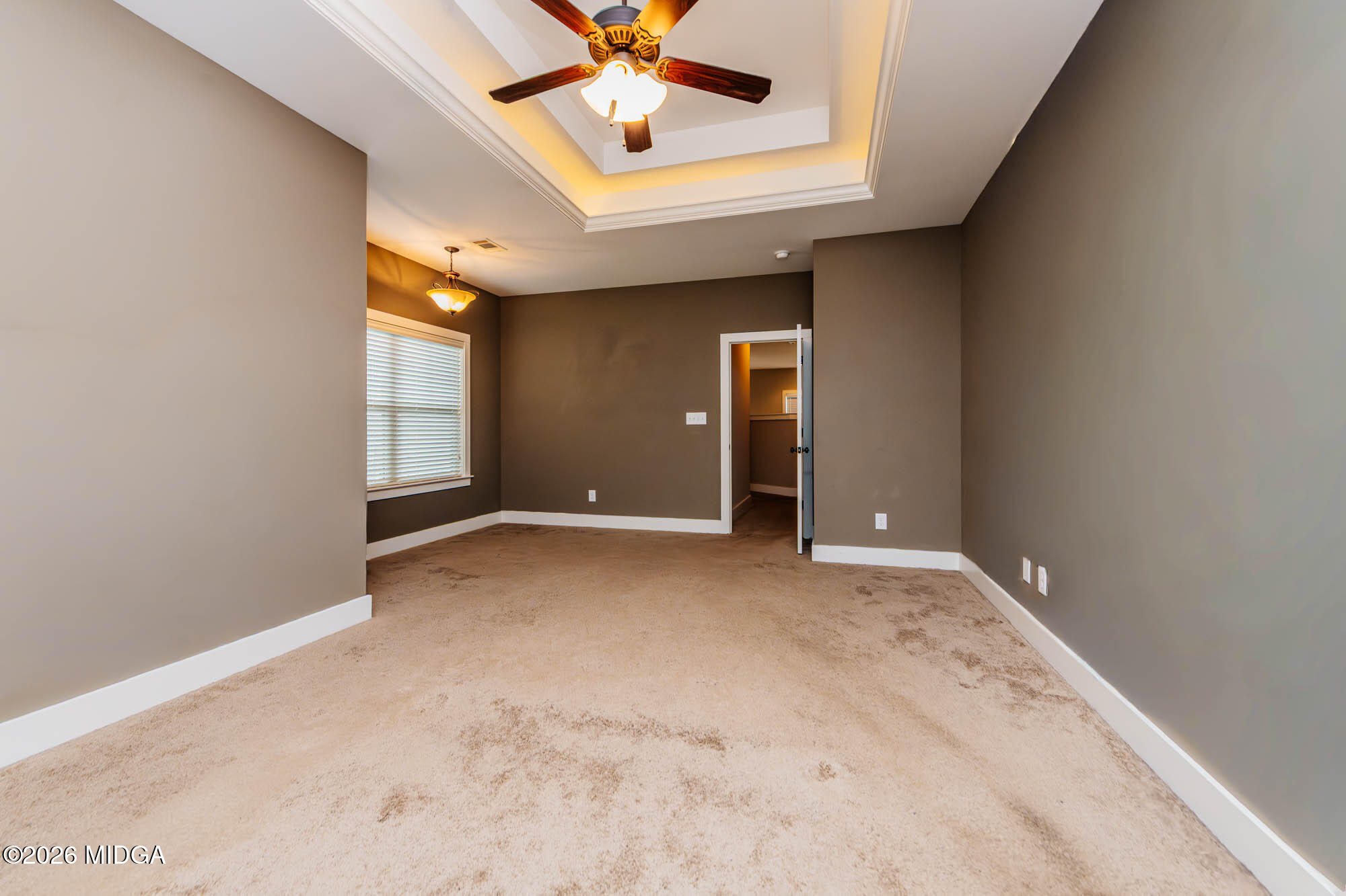 112 Agriculture Lane Perry, GA 31069 - Photo 19 of 40 an empty room with a ceiling fan and window