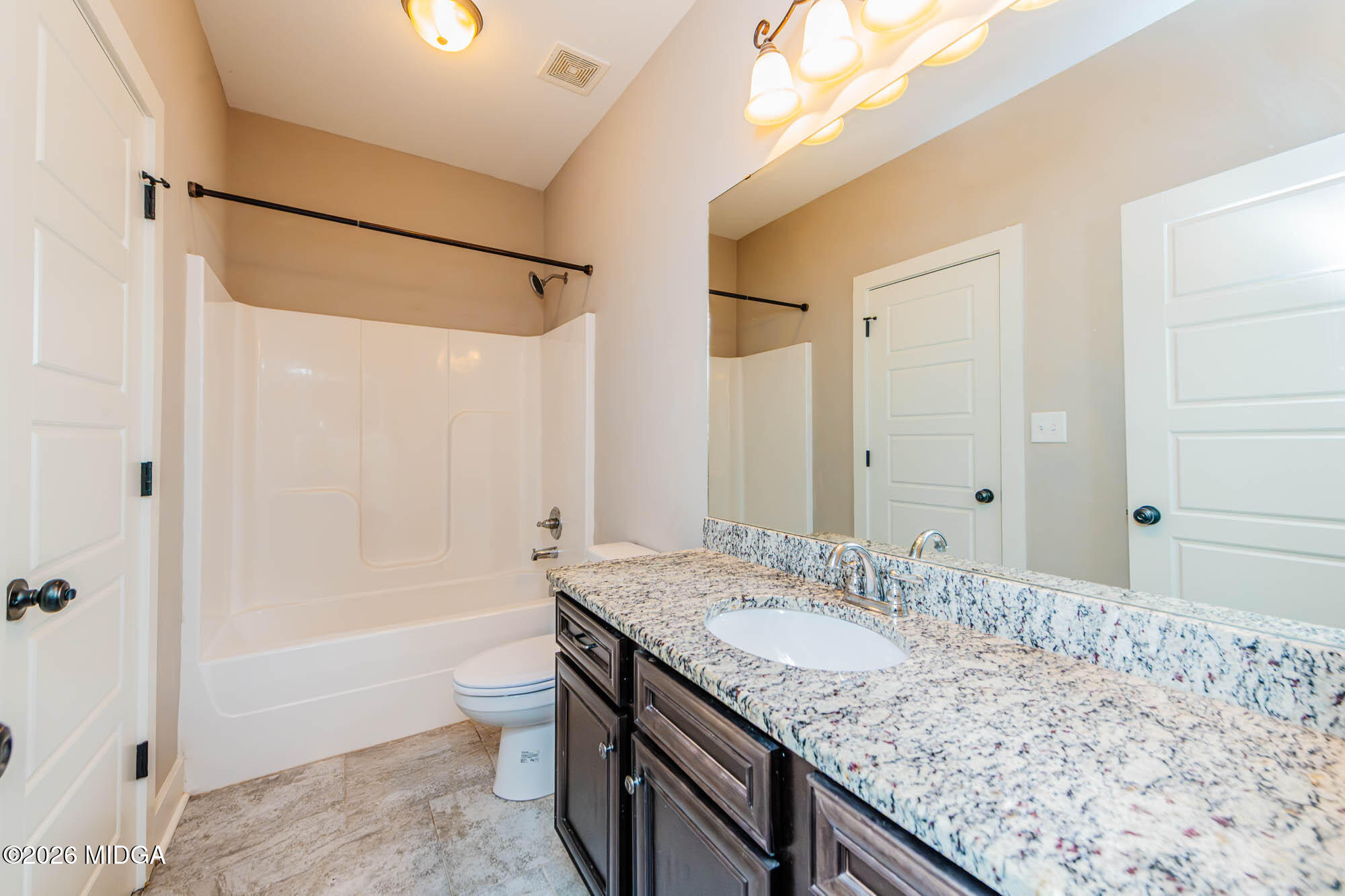 112 Agriculture Lane Perry, GA 31069 - Photo 27 of 40 a bathroom with a granite countertop sink a toilet and shower