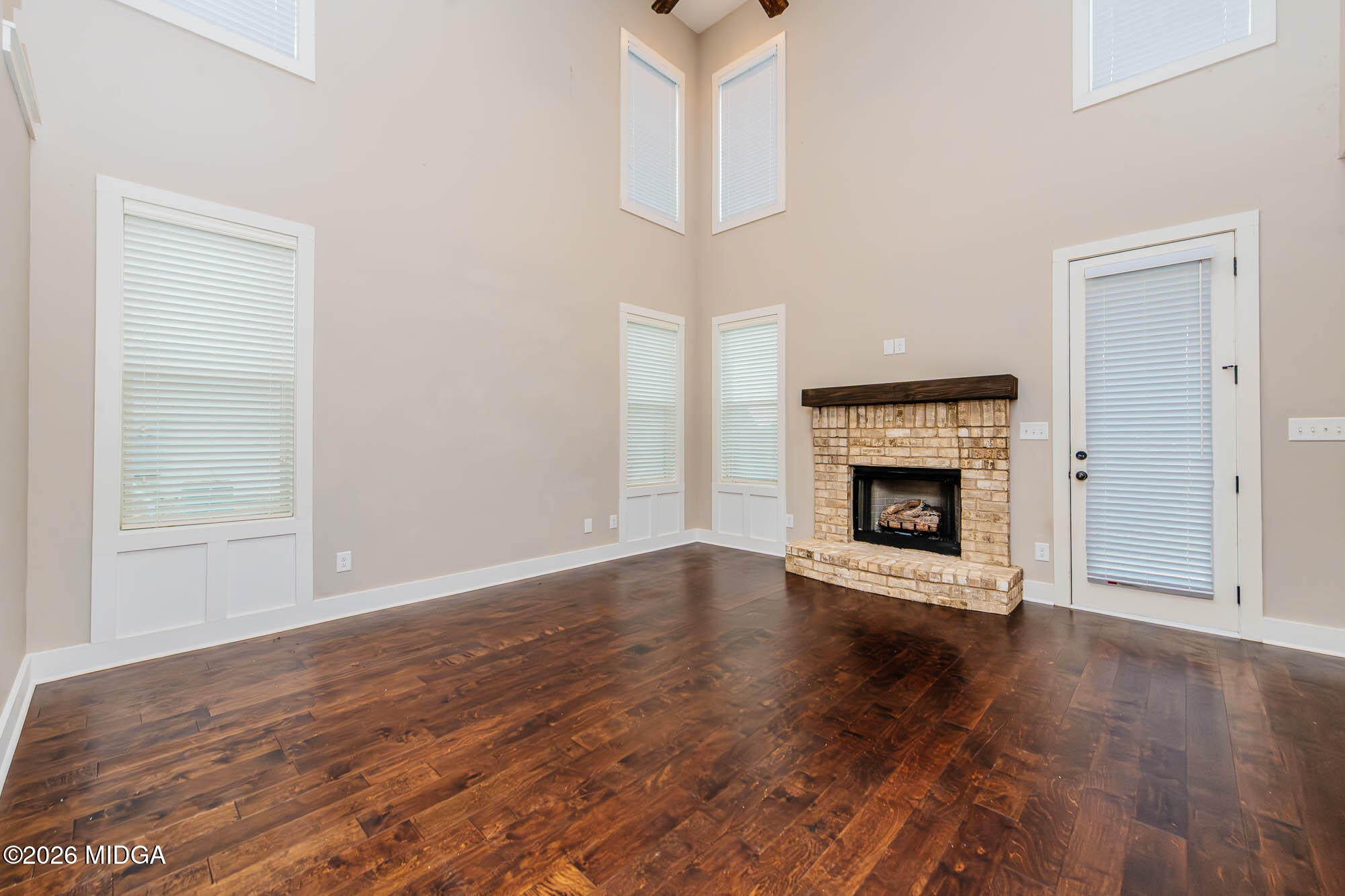 112 Agriculture Lane Perry, GA 31069 - Photo 6 of 40 a view of an empty room with wooden floor fireplace and a window