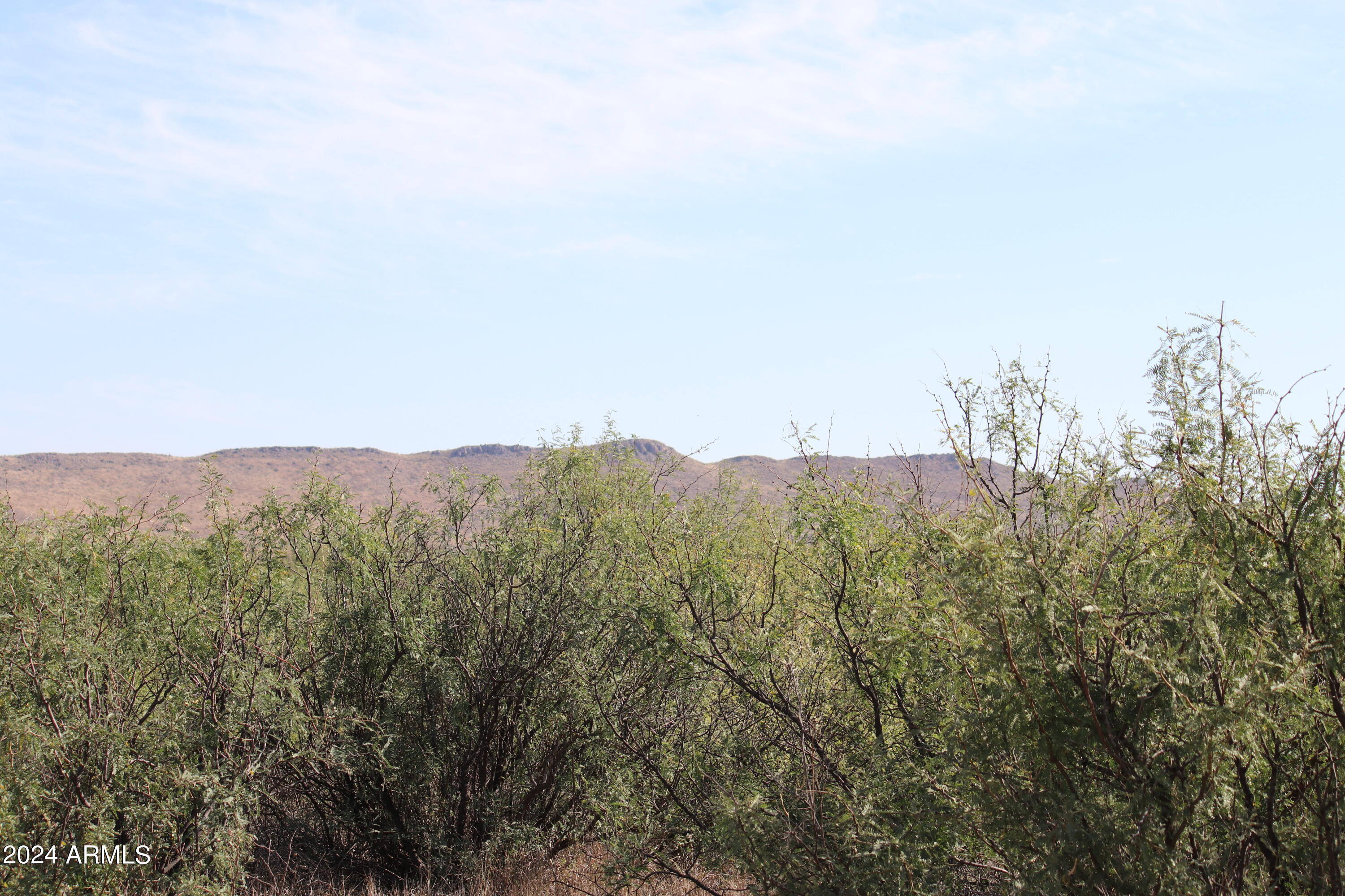 Tbd088 East Antelope Road, Unit 34 Pearce, AZ 85625 - Photo 2 of 5 a view of a large building with mountains in the background