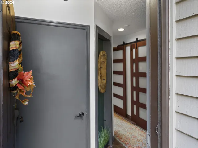 a view of a hallway with wooden shelves