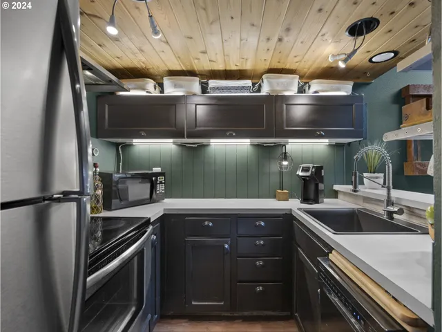 a kitchen with a sink and stainless steel appliances