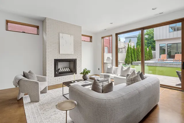 a living room with furniture a fireplace and a table