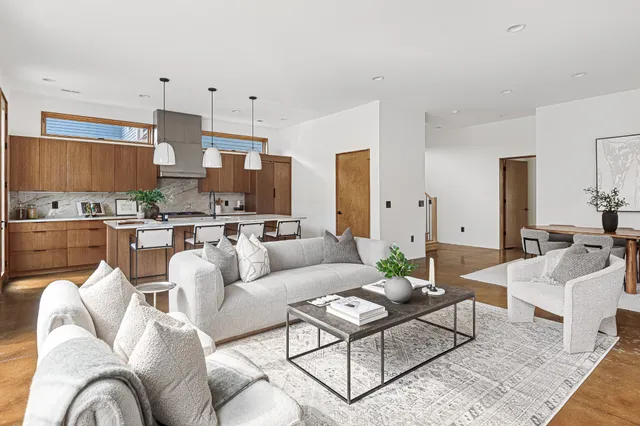 a kitchen with a table chairs sink and cabinets
