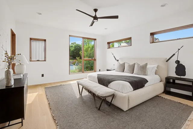 a bathroom with a white tub shower and sink