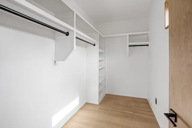 a close view of a sink and dishwasher with cabinets