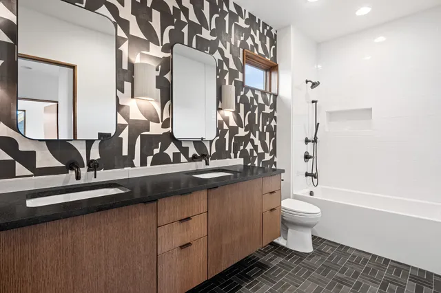 a view of a patio with a table and chairs in front of house