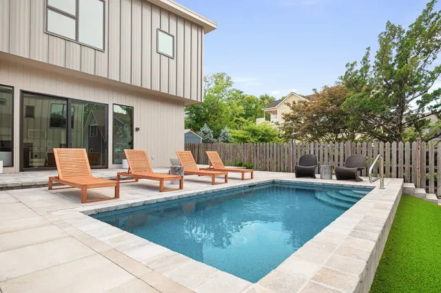 a bathroom with a granite countertop sink a toilet and mirror
