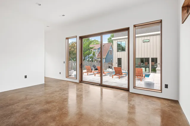 an aerial view of a house with a garden and yard