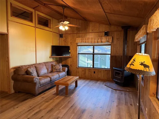 a kitchen with stainless steel appliances granite countertop a refrigerator sink and wooden cabinets