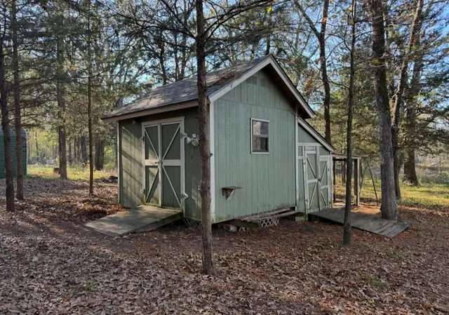 a backyard of a house with barbeque oven