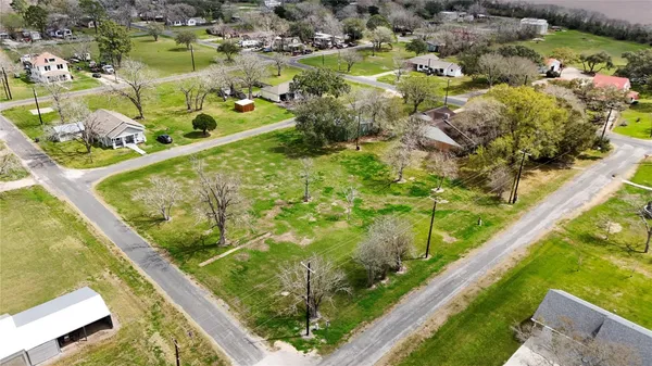an aerial view of residential houses with outdoor space and swimming pool