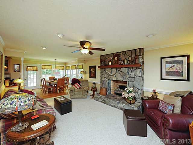 611 East Sandy Ridge Road Monroe, NC 28112 - Photo 3 of 16 a living room with furniture a fireplace and a flat screen tv