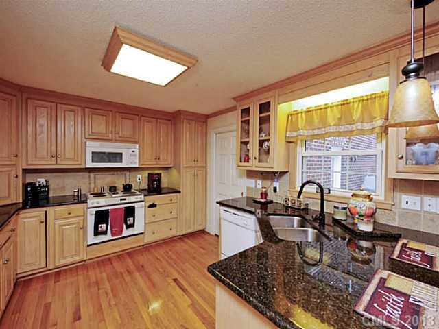 611 East Sandy Ridge Road Monroe, NC 28112 - Photo 7 of 16 a kitchen with stainless steel appliances granite countertop a stove top oven a sink dishwasher and cabinets with wooden floor