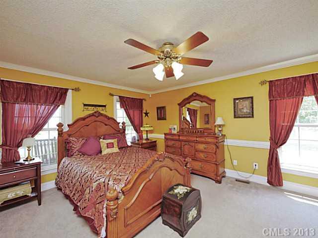 611 East Sandy Ridge Road Monroe, NC 28112 - Photo 9 of 16 a bedroom with two beds and a chandelier