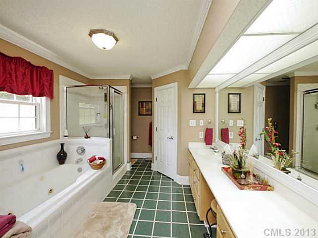 611 East Sandy Ridge Road Monroe, NC 28112 - Photo 10 of 16 a bathroom with a tub sink and mirror