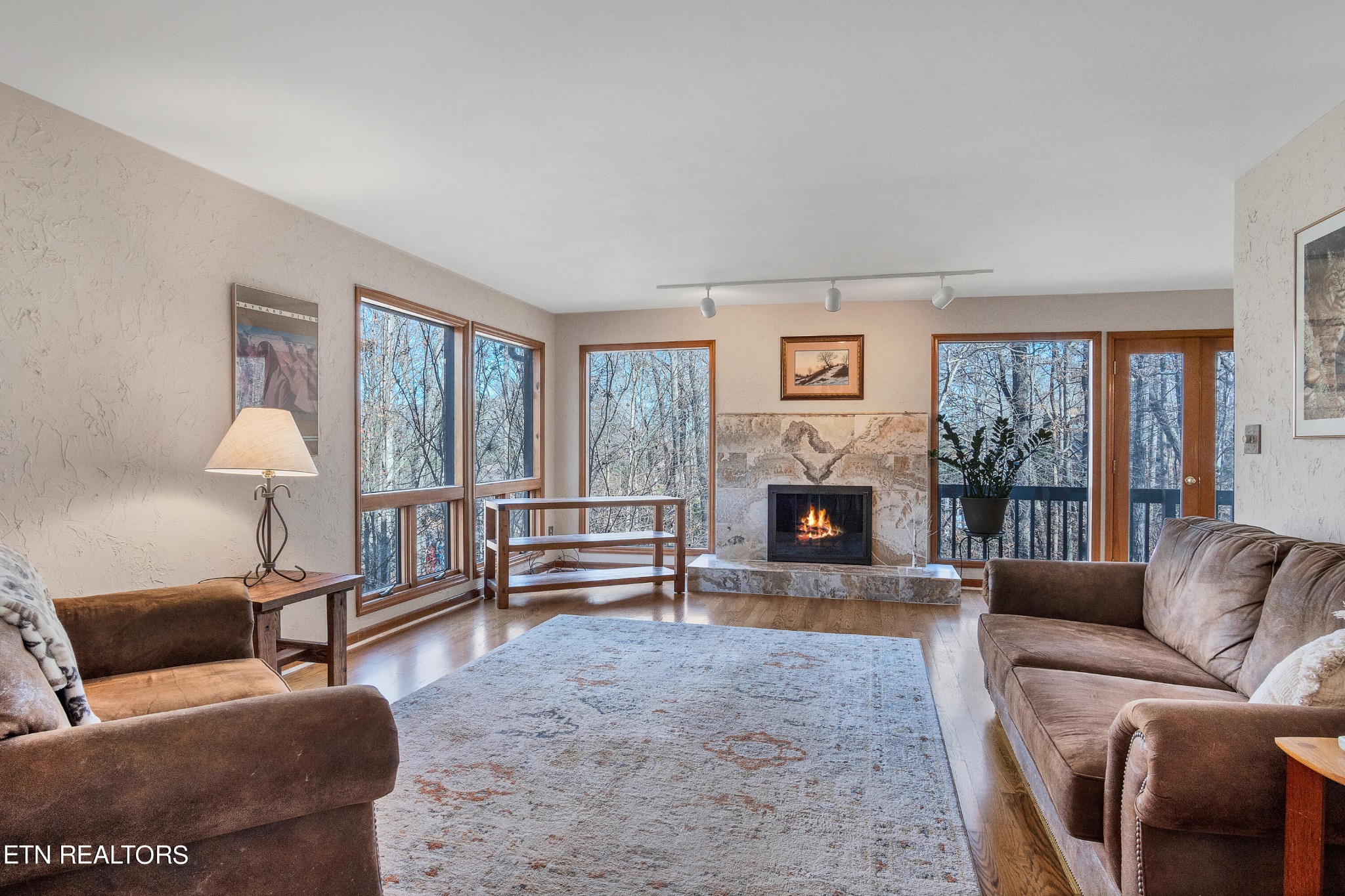 105 Clayton Way Oak Ridge, TN 37830 - Photo 17 of 42 a living room with furniture a large window and a fireplace