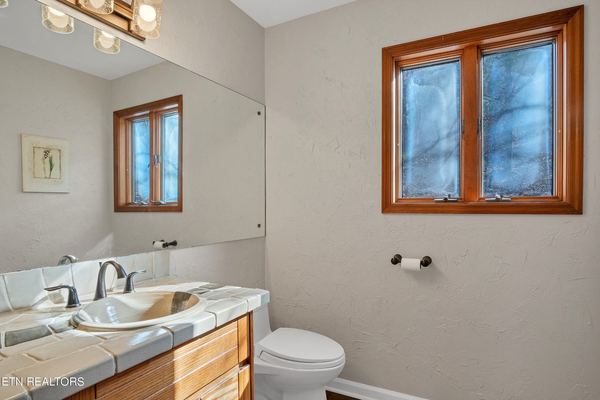105 Clayton Way Oak Ridge, TN 37830 - Photo 18 of 42 a bathroom with a toilet sink vanity and mirror