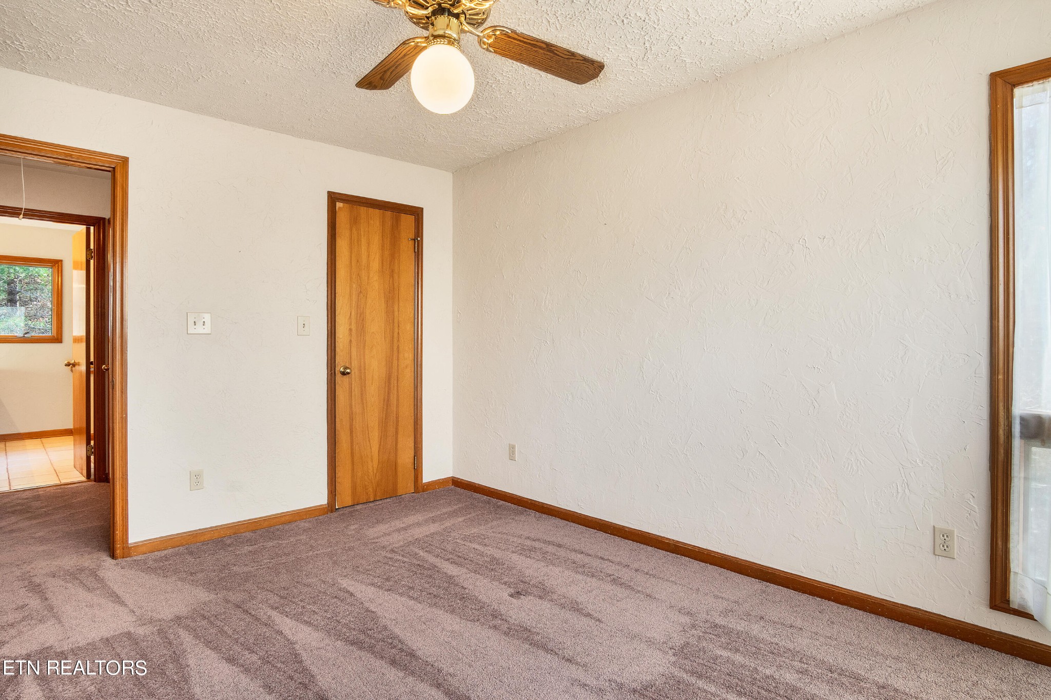105 Clayton Way Oak Ridge, TN 37830 - Photo 31 of 42 an empty room with a chandelier fan and wooden floor