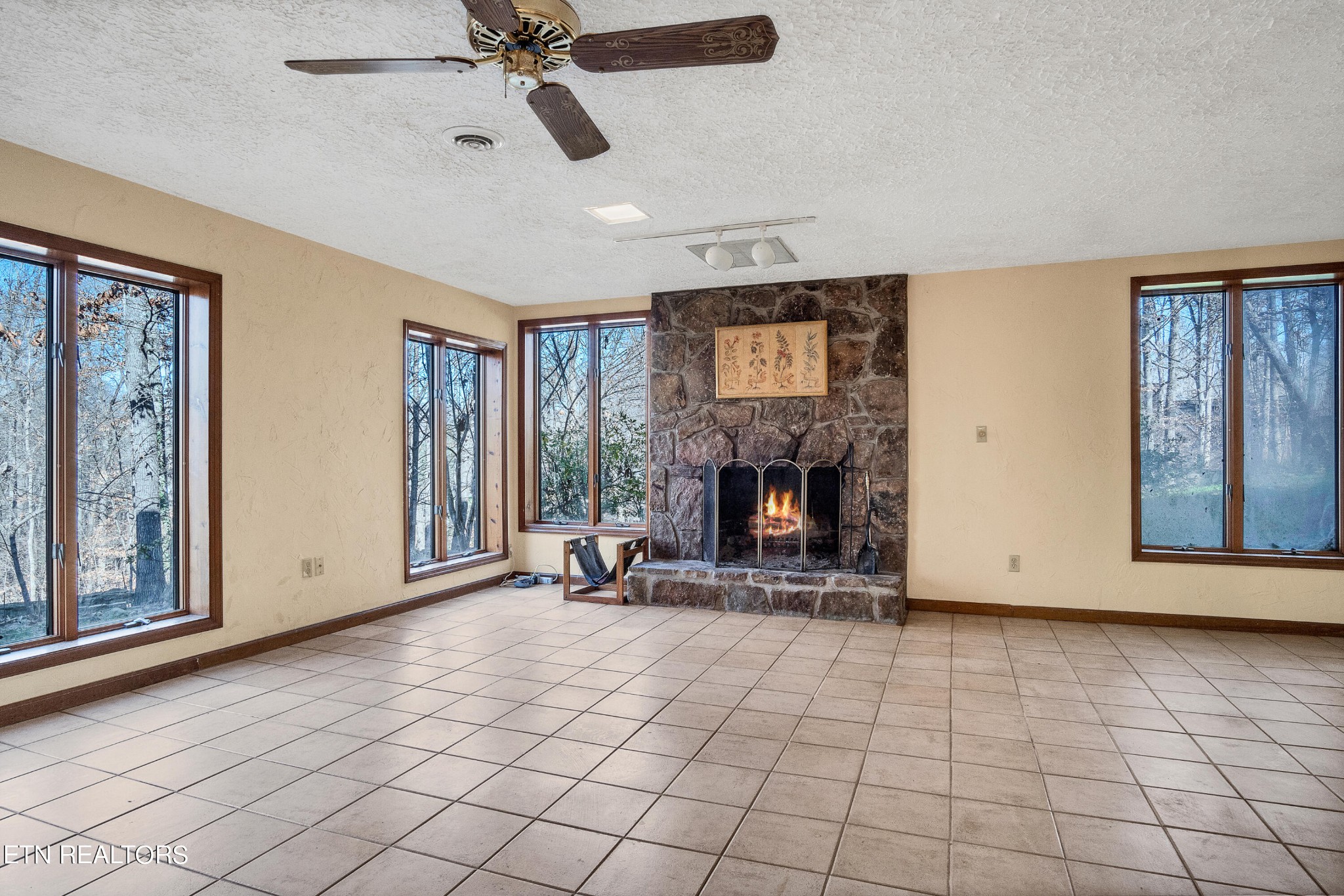 105 Clayton Way Oak Ridge, TN 37830 - Photo 35 of 42 a view of an empty room with a fireplace and a window