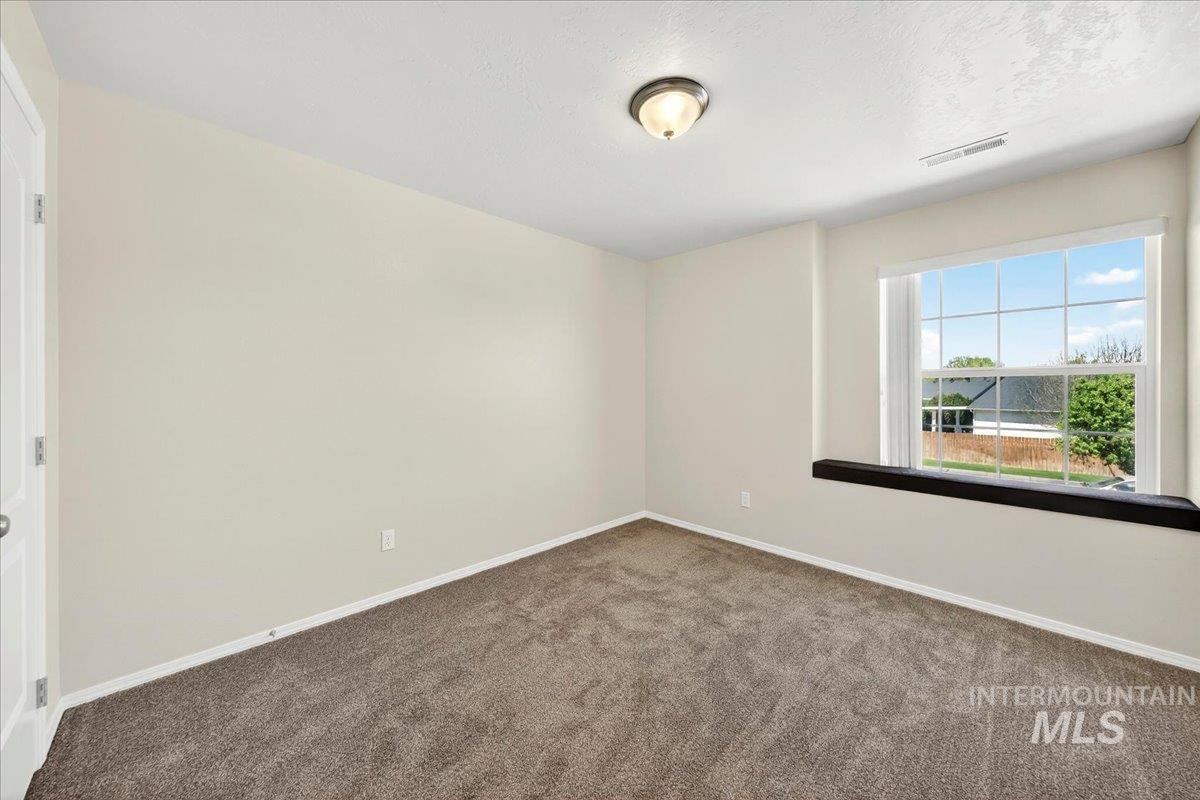 1555 Condor Drive Middleton, ID 83644 - Photo 24 of 50 Carpeted room featuring a double-paned window, neutral wall paint, and a semi-flush mount ceiling light