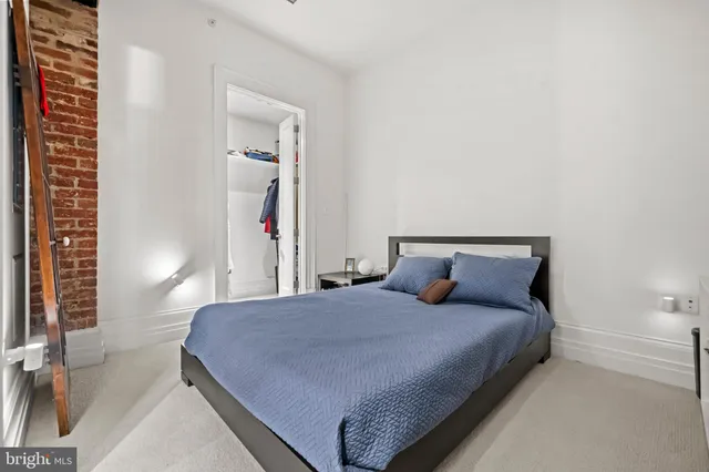 a bedroom with a bed and a night stand